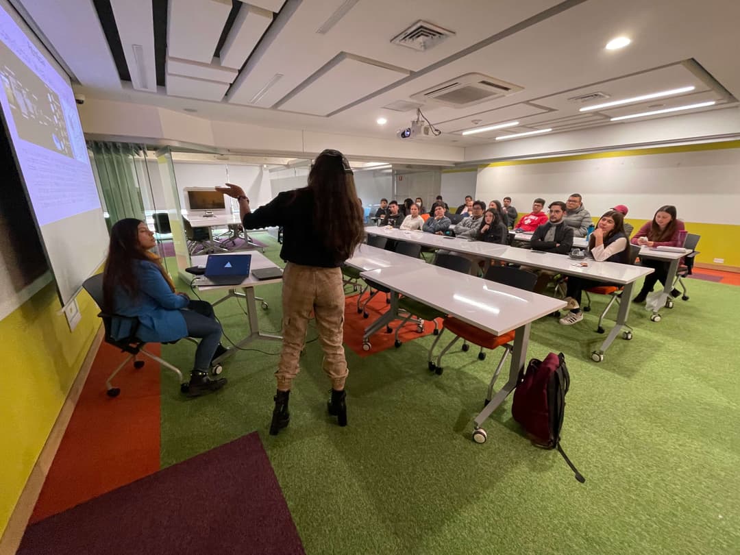 A university classroom with a girl in the middle giving a talk