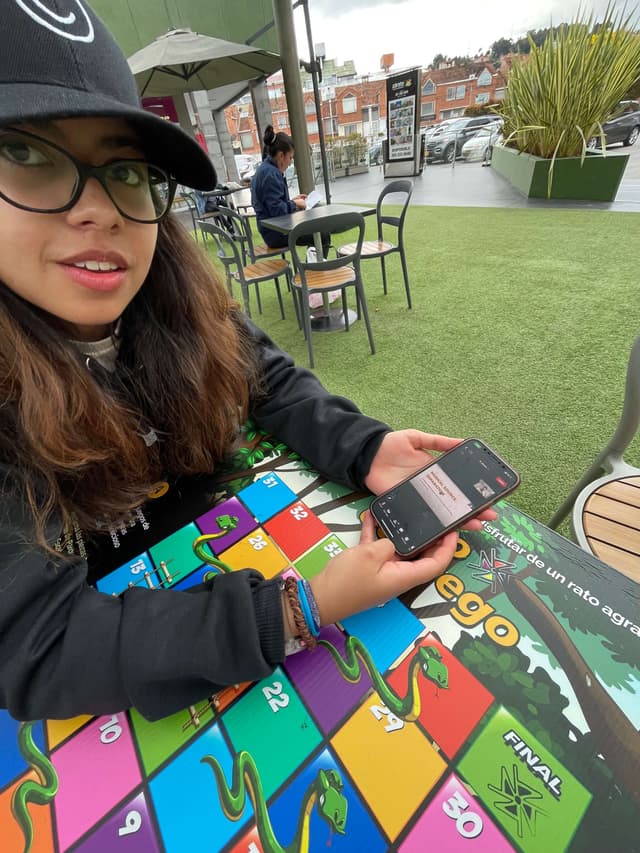 A girl sitting with a phone in her hand