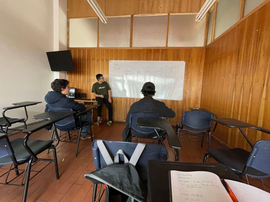 A classroom with a whiteboard filled with diagrams and code